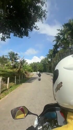 Motorcycle ride through lush Karon roads on a sunny morning