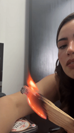 Woman performs Palo Santo cleansing ritual in Mexico home