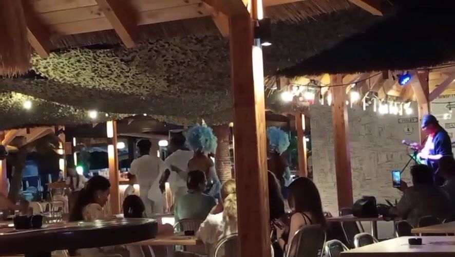 Live music and dancing at a thatched outdoor venue in Boreti