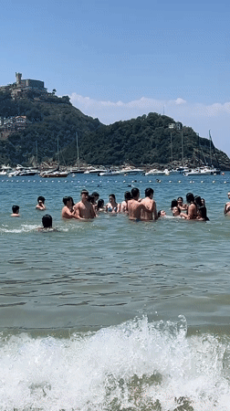 Paddleboarding and beach play on a sunny San Sebastián afternoon