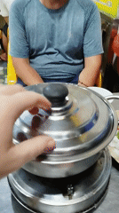 Vietnamese street meal prepared on portable burner in Ho Chi Minh City