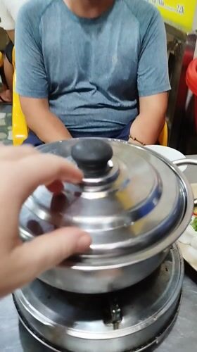 Vietnamese street meal prepared on portable burner in Ho Chi Minh City