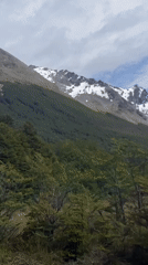 Tourist documents mountain scenery, forest selfies in Ushuaia