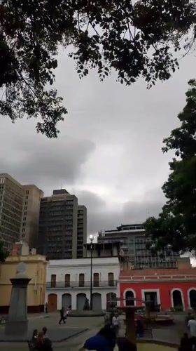 Evening street life documented across central Caracas plaza area