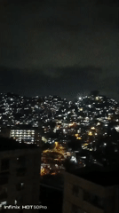 Nighttime Caracas captured from above, children play indoors