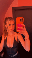 Woman Takes Mirror Selfies in Pink-Lit Berlin Bathroom