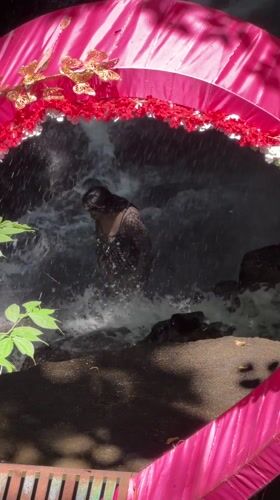 Early morning waterfall tourism activity documented in Indonesia