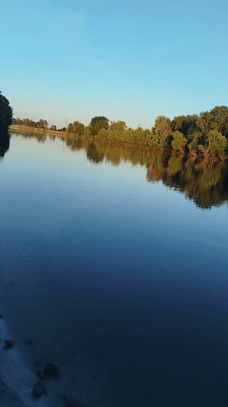 Quiet afternoon at a wide river, dusk settling in