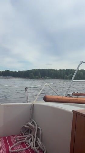 Sailing on calm Russian waters near Chaikovsky, midsummer afternoon