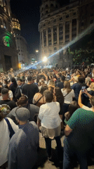 Large crowd gathers on Buenos Aires street at night