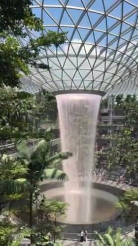 Early morning visitors capture Jewel Changi Airport's waterfall attraction