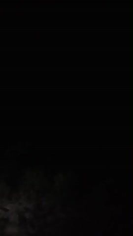The video is extremely dark, showing only a faint, blurred image at the bottom. It is impossible to discern any people, objects, actions, interactions, or specific environmental details. The image appears to be either a very low-light recording or a poorly exposed photograph.