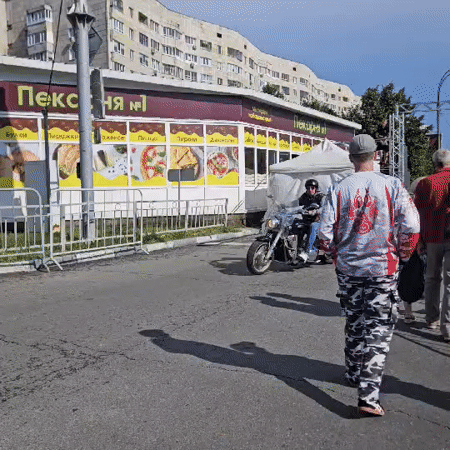Street festival scene in Ulyanovsk with food stalls and motorcycles