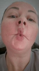 Person makes fish-face expression on camera in Kemerovo
