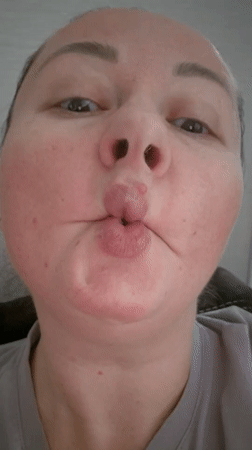 Person makes fish-face expression on camera in Kemerovo