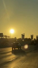 Sunset drive on a Burbank highway, palm trees in the background