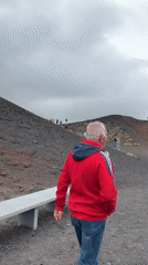 Tourists explore Mount Etna's volcanic slopes near Nicolosi