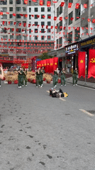 Military-uniformed group performs synchronized street dance in Vietnam