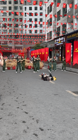 Military-uniformed group performs synchronized street dance in Vietnam
