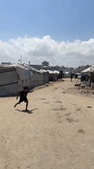Children play soccer in Gaza tent settlement