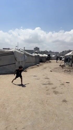 Children play soccer in Gaza tent settlement