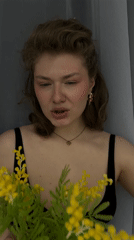 Woman poses with yellow flower bouquet in Russia