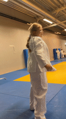 Youth judo class drills with foam noodles on gym mats