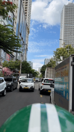 Motorcycle POV through Nha Trang's sunny city streets
