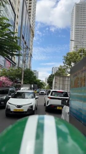 Motorcycle POV through Nha Trang's sunny city streets