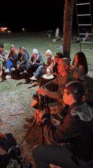 Nighttime bonfire gathering with drumming and dance in Kazakhstan