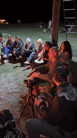 Nighttime bonfire gathering with drumming and dance in Kazakhstan