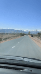 Driver records mountain scenery on Kyrgyzstan road