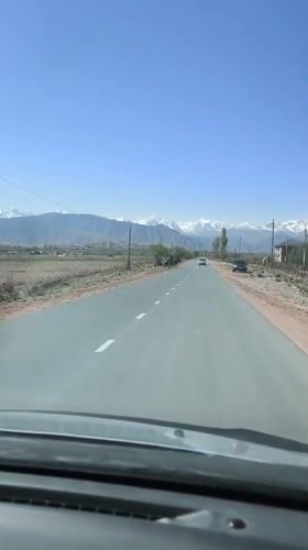 Driver records mountain scenery on Kyrgyzstan road