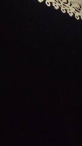The video shows a dark background with a decorative, light-colored border visible at the top. A thin stream of water appears intermittently, running vertically from the top of the frame.