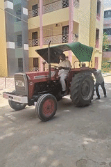 Morning scenes in Puttaparthi: tractor assistance and garden ornament