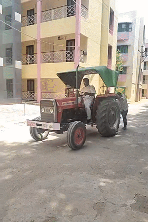 Morning scenes in Puttaparthi: tractor assistance and garden ornament