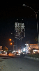 Damaged billboard with torn advertisement observed in Lhokseumawe