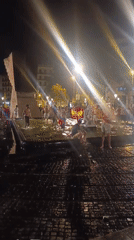 Barcelona crowd celebrates at night in red and yellow
