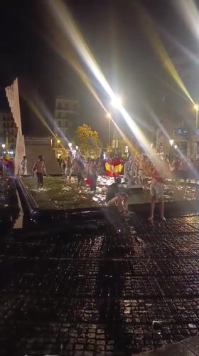 Barcelona crowd celebrates at night in red and yellow