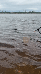 Fishing documented along waterway near Chaikovsky, Russia under cloudy skies