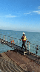 Safety gear and metal ramps at a Ko Samui waterside work site