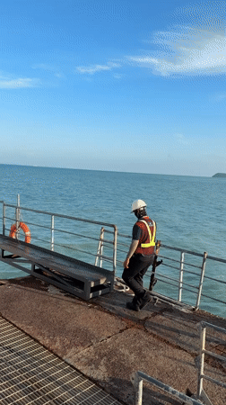 Safety gear and metal ramps at a Ko Samui waterside work site