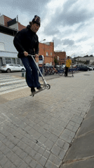 Masked scooter rider performs street tricks in Badalona