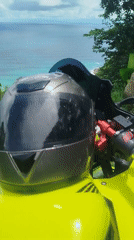 Yellow motorcycle parked at a scenic Phuket coastal overlook