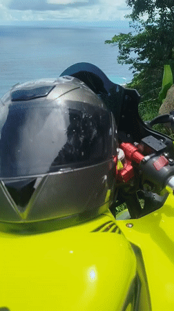 Yellow motorcycle parked at a scenic Phuket coastal overlook