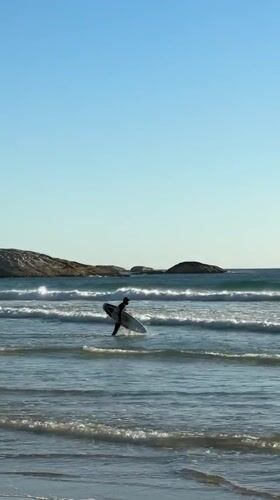 Surfers active in clear conditions at Hout Bay beach