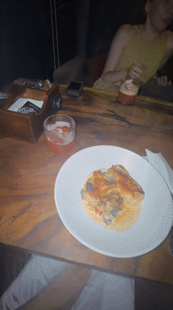 Restaurant diners document lunch meals across multiple locations