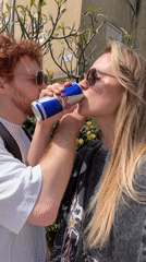 Couple spotted outdoors, #EnergyBooster text captured in Bat Yam