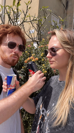 Couple spotted outdoors, #EnergyBooster text captured in Bat Yam