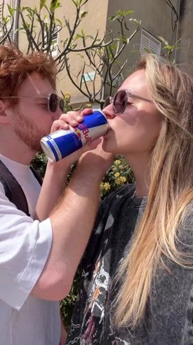 Couple spotted outdoors, #EnergyBooster text captured in Bat Yam